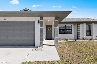 View of front facade with a garage and a front yar