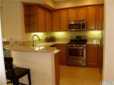 Upgraded kitchen with granite counters and curved 