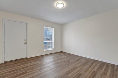 Foyer entrance with wood-type flooring and a textu