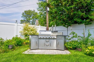 Fenced backyard featuring an outdoor kitchen