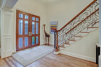 The light filled foyer area with an iron scroll ba