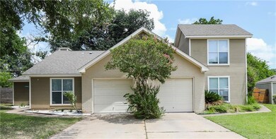 View of front facade featuring a garage, driveway