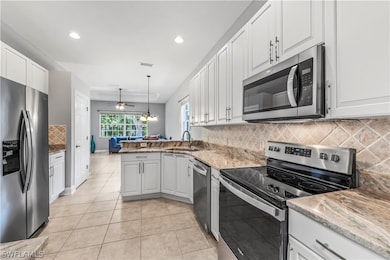 Brand new kitchen.  It is gray and white.  
