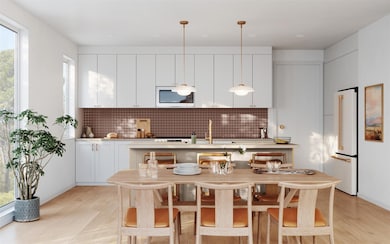 Kitchen featuring light countertops, tasteful bac