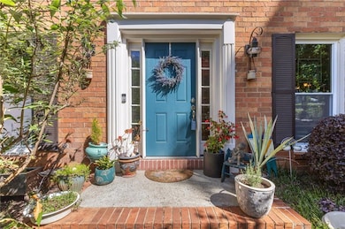 Doorway to property with brick siding