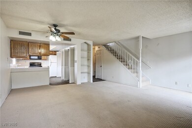 Unfurnished living room featuring stairs, visible