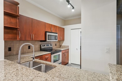 Kitchen with decorative backsplash, stainless stee