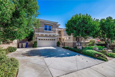 Front of home with large driveway.