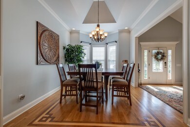 The Formal Dining Room (11x13) has an inverted hip vaulted tray ceiling, Crown Molding, Decorative Wood Trim, Chandelier, Recessed accent lighting, Bay Window and Hardwood floor inlay.