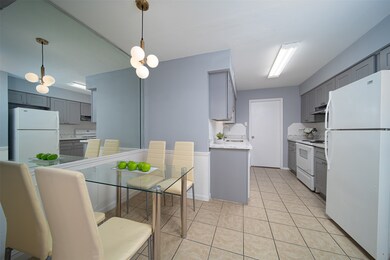 The breakfast room is next to the kitchen with new light fixture.