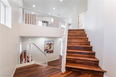 Staircase with recessed lighting, baseboards, wood