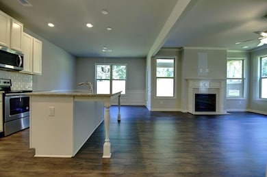 Kitchen featuring white cabinetry, a center island