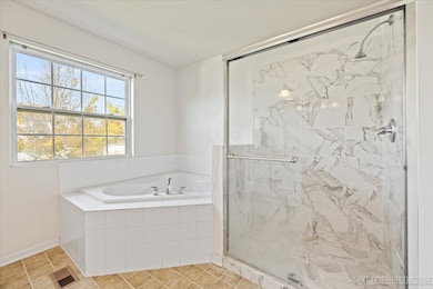 Relax in the updated primary bath featuring a walk