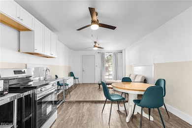 Dining room with light wood-type flooring and a ceiling fan