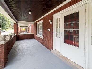 An expansive front porch is inviting for guests an