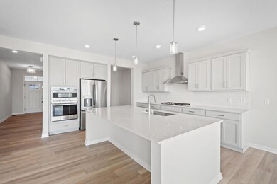 This lifestyle gourmet kitchen features stainless steel hood, gas cooktop, GE appliances, and modern subway tile backsplash that adds a touch of sophistication.  A Home Chef's dream space ideal for both everyday living and entertaining!
