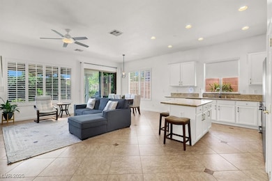 Kitchen featuring a center island, white cabinetry