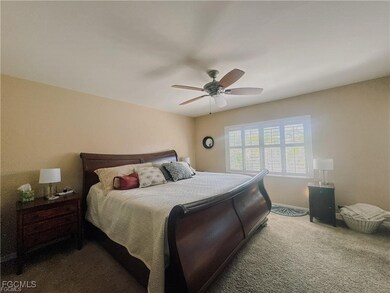 Carpeted bedroom with ceiling fan