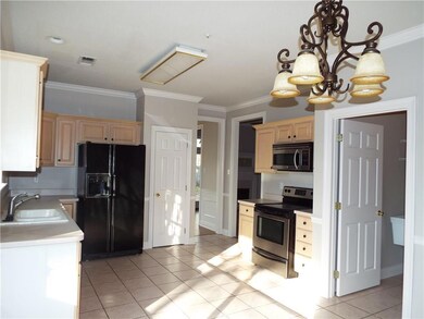 Kitchen with ceramic tile flooring and crown moldi