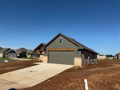 View of front of home featuring brick siding, cooling unit, concrete driveway, and a residential view