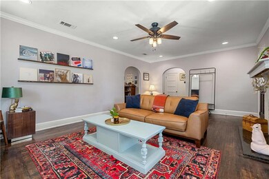 Living area featuring arched walkways, visible ven