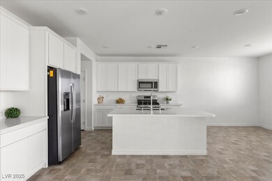 Kitchen with stainless steel appliances, light cou