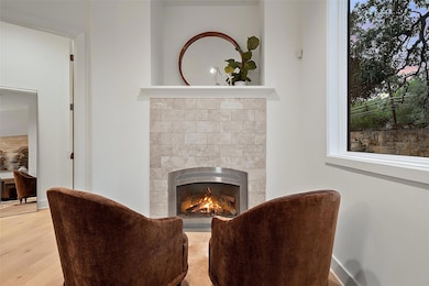 Living area featuring a fireplace, heating unit, 