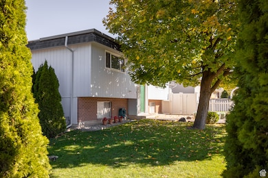 Rear view of property with a patio and brick siding