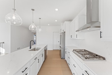 (Photo of an inventory home, actual homes finishes will vary) The gourmet kitchen features a large center island, quartz countertops, LVP floors, stainless steel appliances, and more.