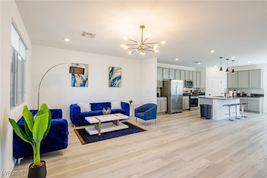 Living area with a chandelier, light wood finished