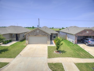 View of front of home with an attached garage, concrete driveway, and brick siding