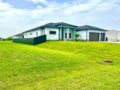 View of front facade with a garage and a front lawn