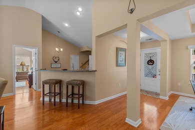 Entrance foyer with lofted ceiling, light wood-style floors, a chandelier, and recessed lighting