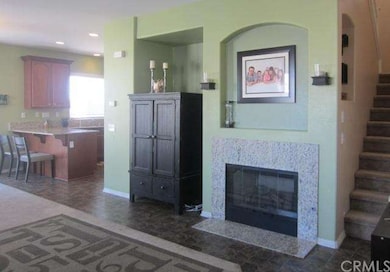 Entry view of living room fireplace, stairs and ki