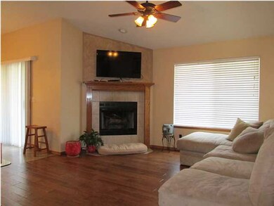 Living room with hardwood floors and fireplace.