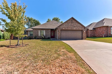 Ranch-style house with brick siding, a shingled roof, a front yard, and concrete driveway