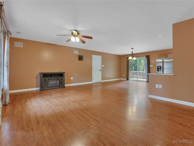 Unfurnished living room featuring ceiling fan, a fireplace, and light wood-type flooring
