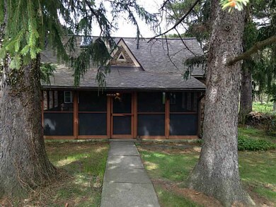 Exterior Front. Peacefully tucked under giant pine