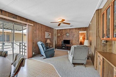 Living room featuring wood walls, visible vents, l