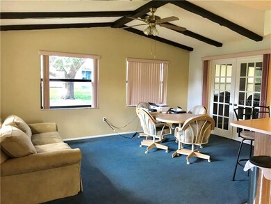 Family room with French doors leading to third bed