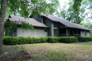 View of side of home featuring roof with shingles,