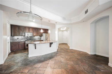 View of open-concept kitchen, front door, and foye
