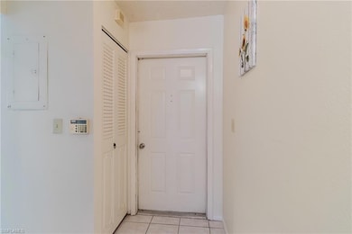 Hall with light tile patterned floors and electric