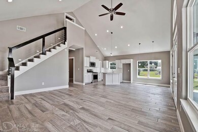 Dramatic contemporary stainless steel cable stair case. Builtin refrigerator and microwave. Gas cook top and oven. Huge pantry.