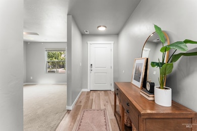 Entrance foyer with light wood finished floors and baseboards