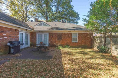 Back of house featuring a lawn, a patio, and frenc