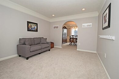 HUGE LIVING ROOM ACCENTED BY CROWN MOLDING AND BRA