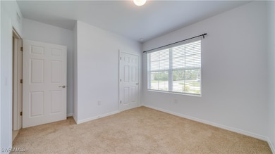 Unfurnished bedroom with carpet floors and a close