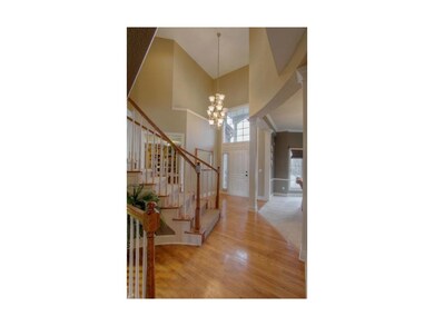 Soaring 2 Story Entry with Sweeping Split Staircas