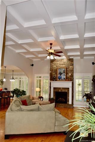 Great room, with coffered ceiling & stone FP